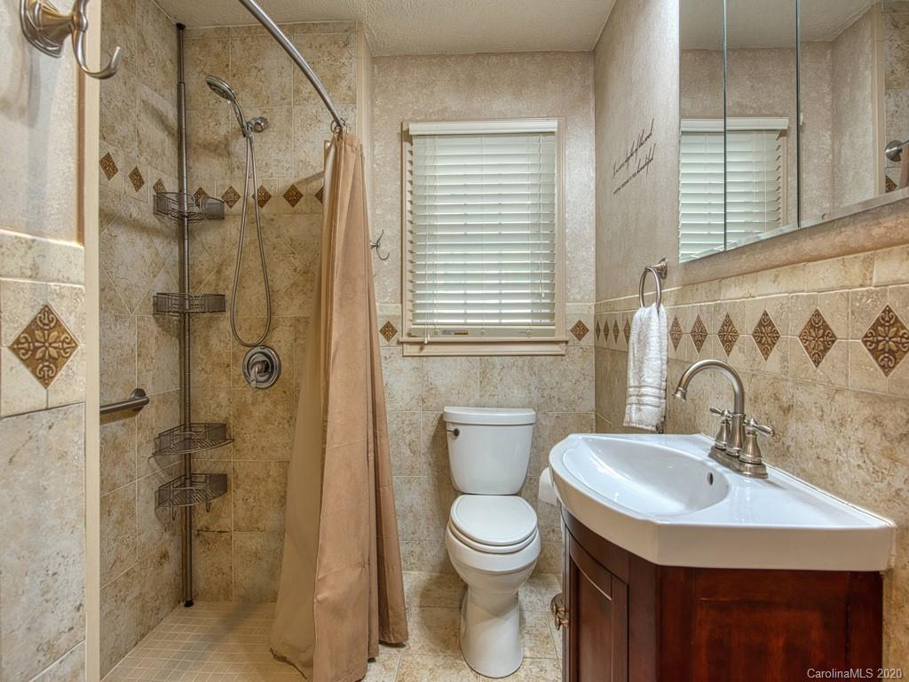 154 Camp Branch Road Waynesville, NC 28786 - Photo 23 of 29 a bathroom with a sink toilet and shower