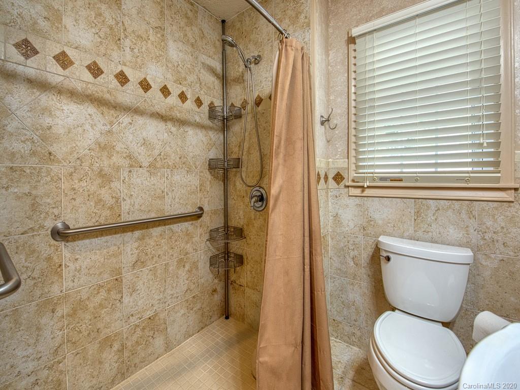 154 Camp Branch Road Waynesville, NC 28786 - Photo 24 of 29 a bathroom with a toilet a sink and a shower