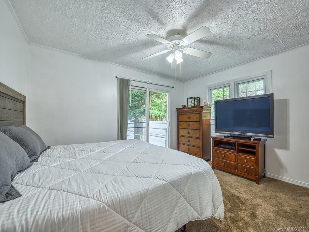 154 Camp Branch Road Waynesville, NC 28786 - Photo 26 of 29 a bedroom with a bed and a flat screen tv