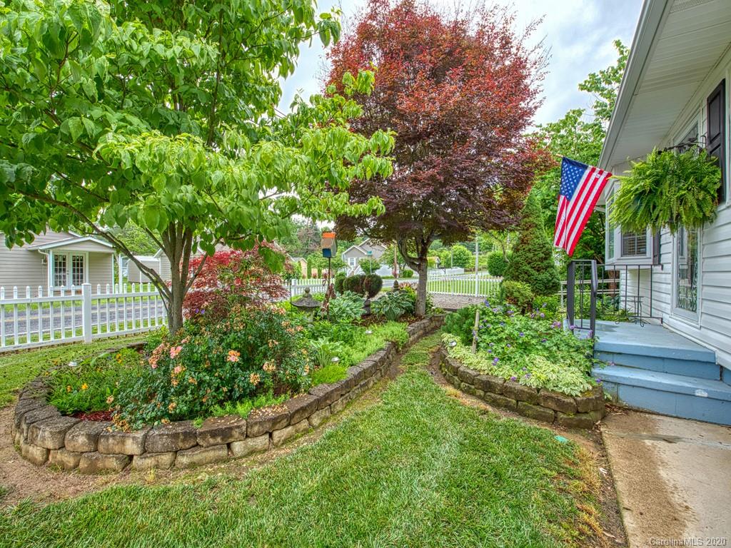154 Camp Branch Road Waynesville, NC 28786 - Photo 5 of 29 a front view of a house with a yard and potted plants