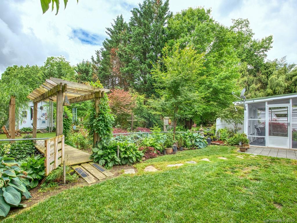 154 Camp Branch Road Waynesville, NC 28786 - Photo 9 of 29 a view of a house with a yard and potted plants