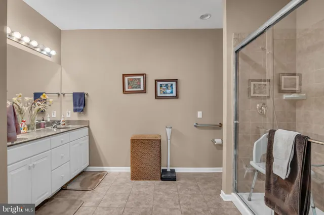 a bathroom with a granite countertop sink a toilet and a mirror