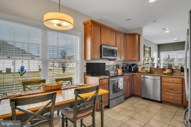 a kitchen with stainless steel appliances kitchen island granite countertop a sink and cabinets