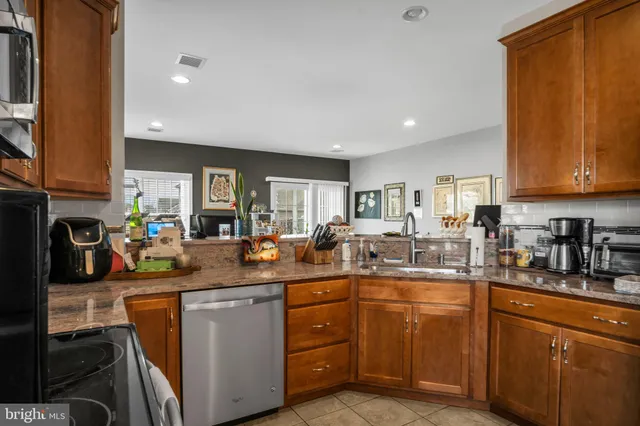 a kitchen with lots of counter space appliances and cabinets