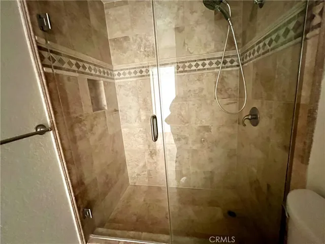a view of a room with wooden floor fan and window