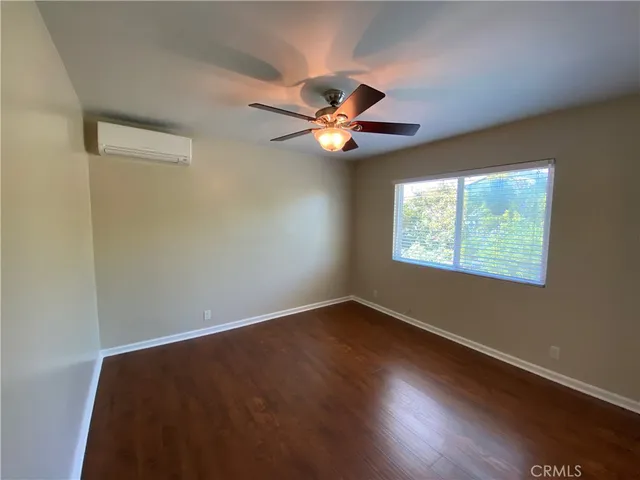 a bathroom with a granite countertop sink a toilet a mirror and shower