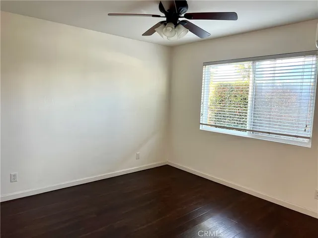 a view of a patio with table and chairs with wooden floor and potted plants