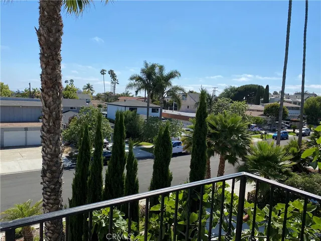 a view of backyard with seating space and potted plants