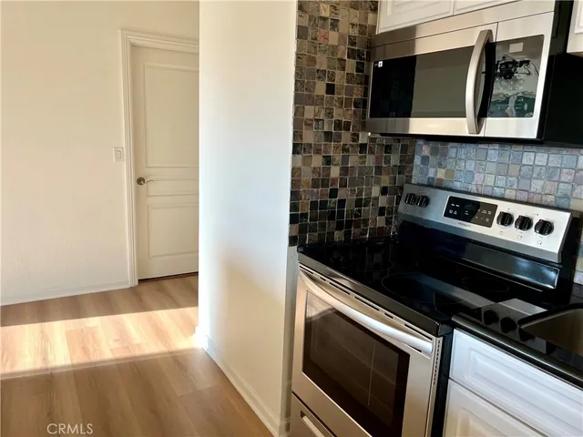 a close view of a stove a microwave and cabinets