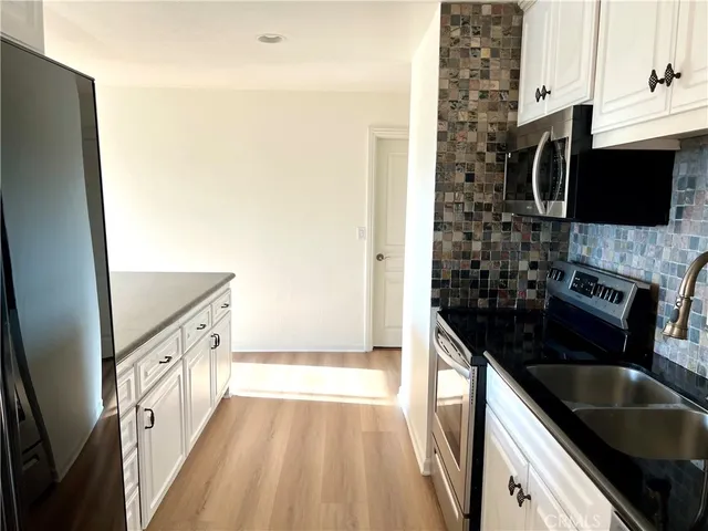 a view of a kitchen from the hallway