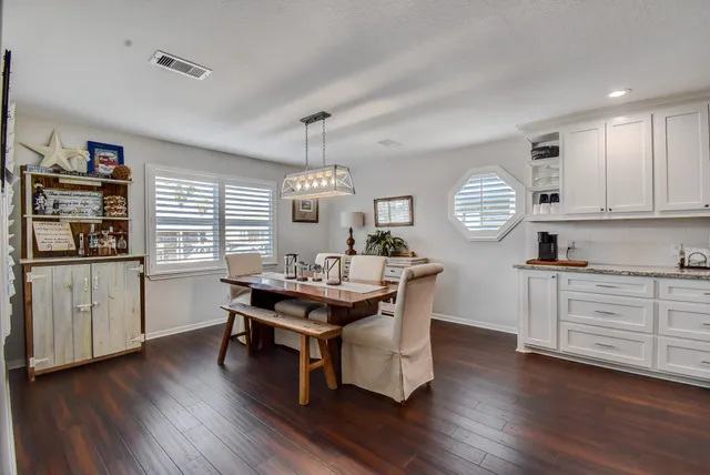 a kitchen with stainless steel appliances kitchen island hardwood floor stove sink and cabinets