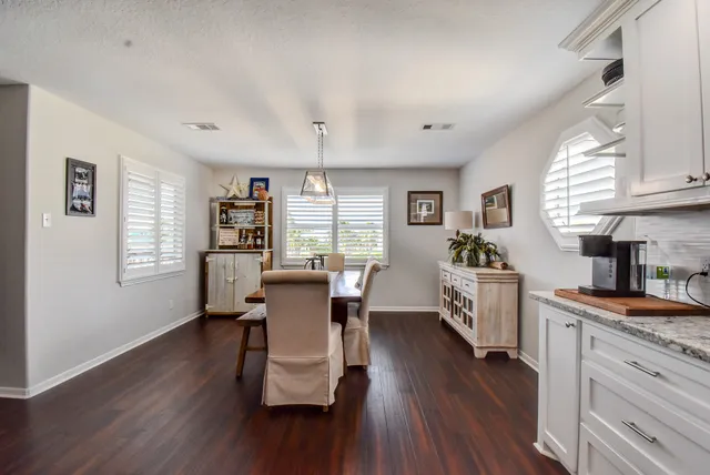 a dining room with furniture and wooden floor