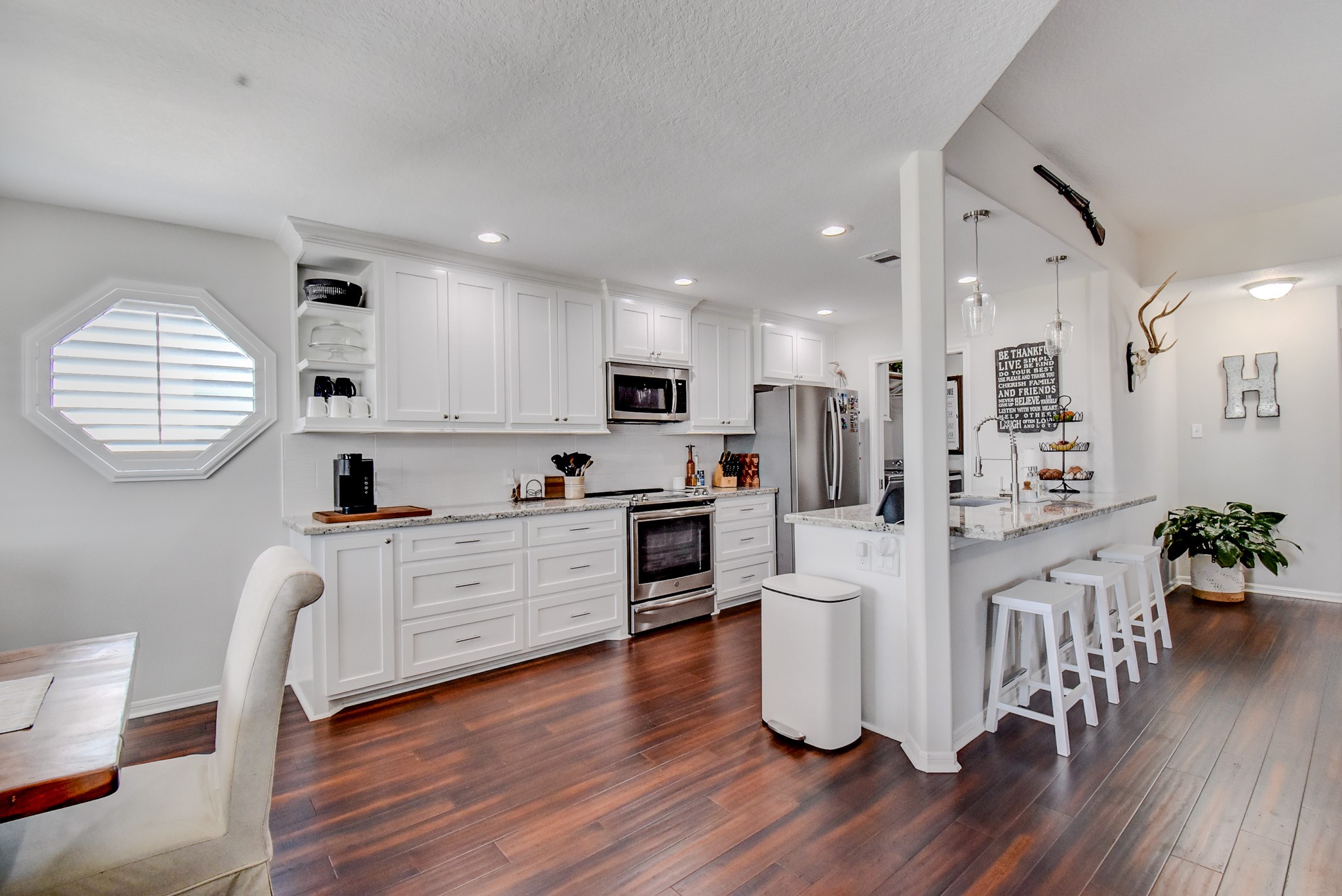122 Four Master Road Freeport, TX 77541 - Photo 22 of 50 a kitchen with white cabinets and stainless steel appliances