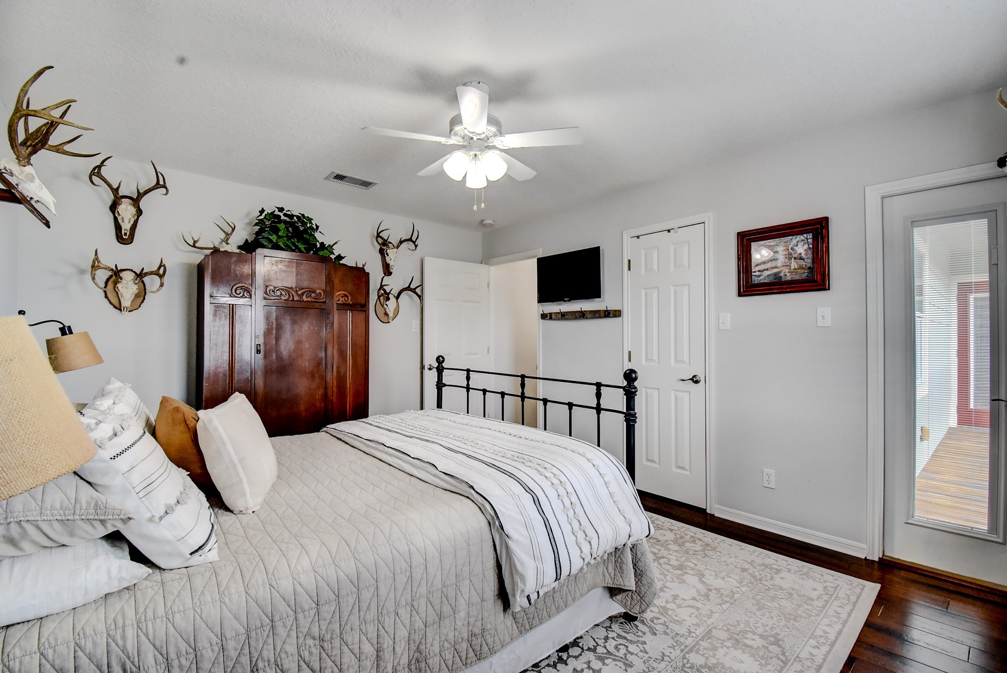 122 Four Master Road Freeport, TX 77541 - Photo 34 of 50 a bedroom with a bed and a chandelier