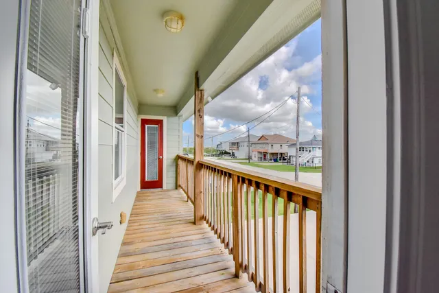 a view of a balcony with wooden floor