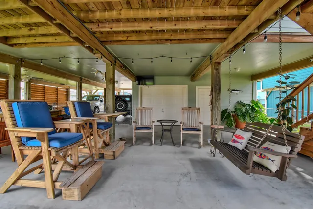 a view of a patio with table and chairs potted plants with wooden fence
