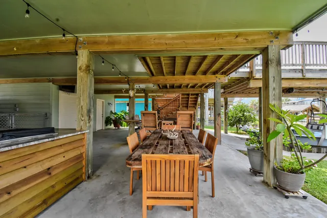 a view of a porch with furniture and garden