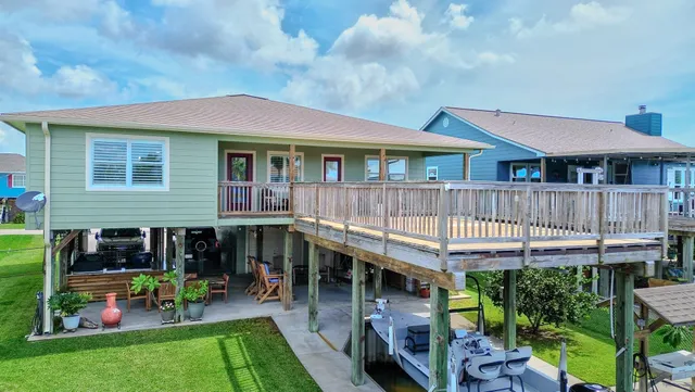 a view of a house with a yard and furniture