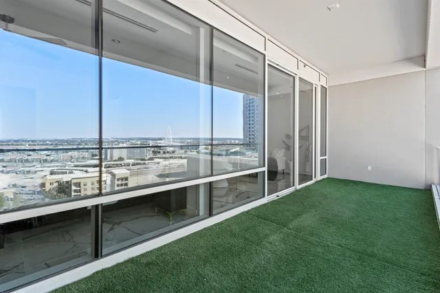 a view of a balcony next to a yard