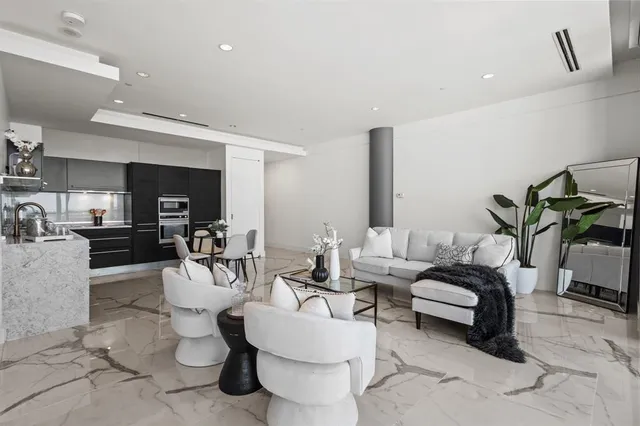a living room with furniture and view of kitchen