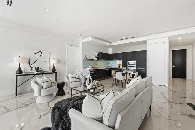 a living room with furniture and kitchen view