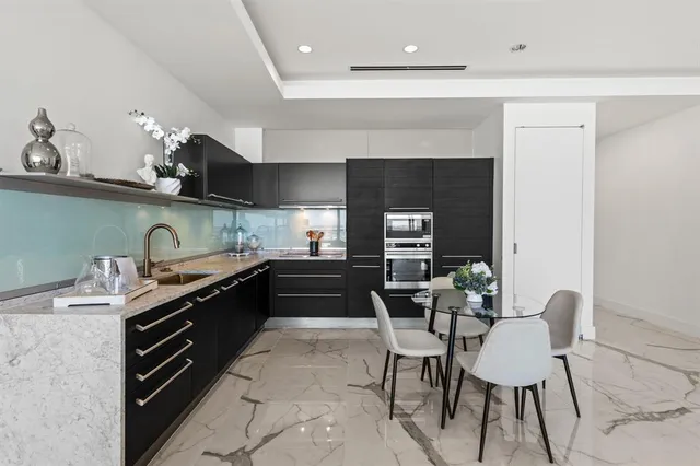 a kitchen with granite countertop a sink and appliances