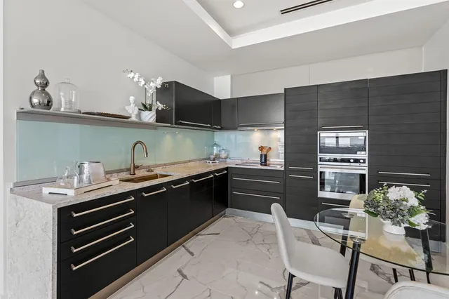 a kitchen with stainless steel appliances kitchen island granite countertop a sink and cabinets