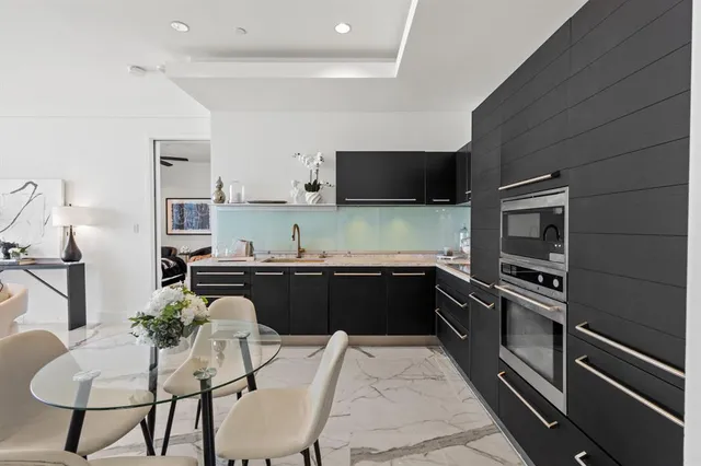 a kitchen with a refrigerator and a stove top oven