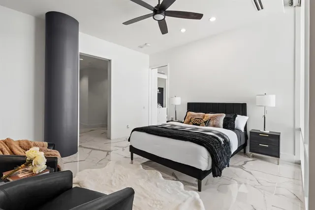 a bedroom with a bed and ceiling fan