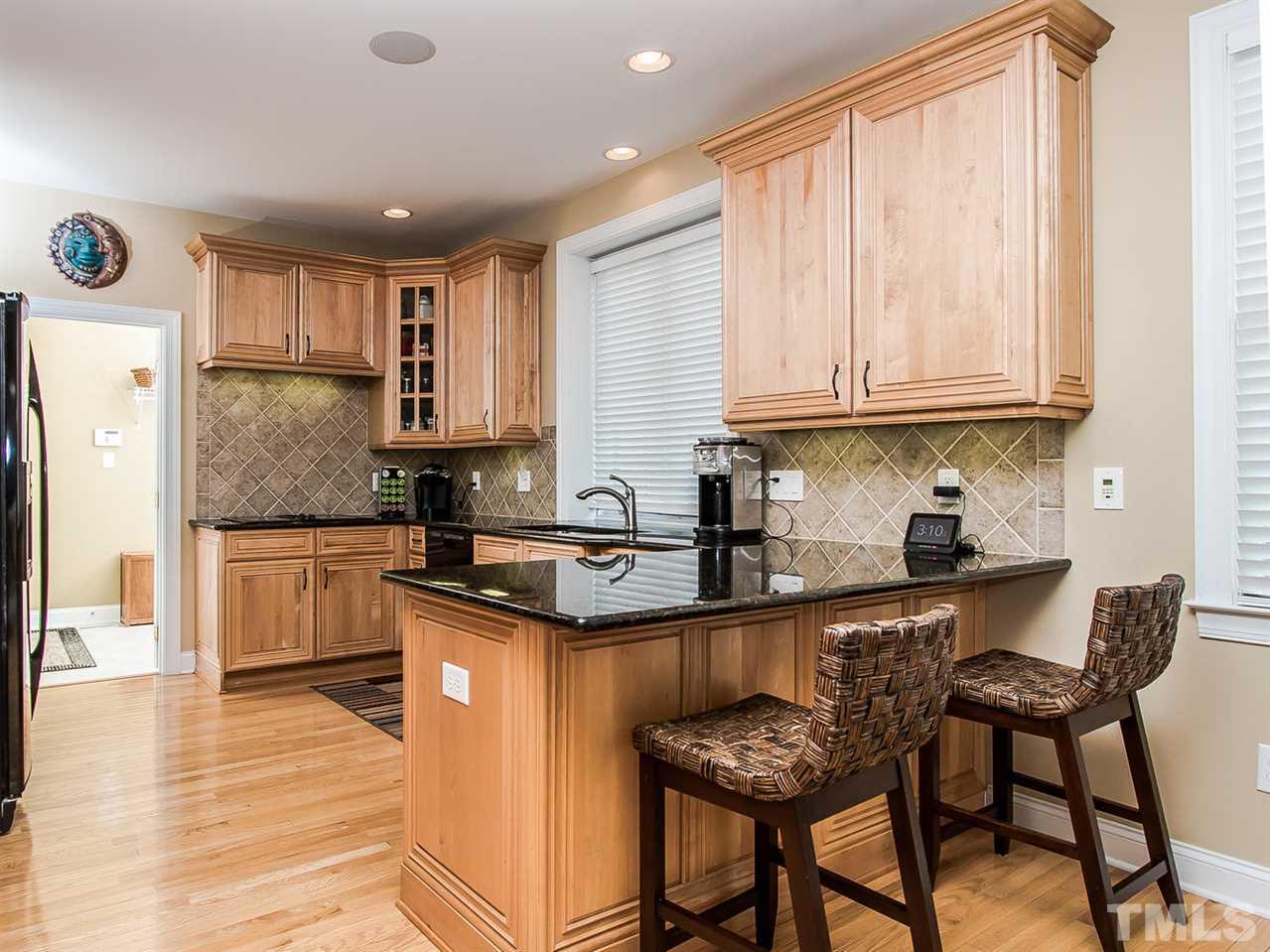 11636 Broadfield Court Raleigh, NC 27617 - Photo 5 of 25 Gourmet kitchen w granite counter tops, new hardware, electric wall oven, recessed lighting, pantry and more.