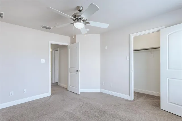 a view of an empty room with a fan
