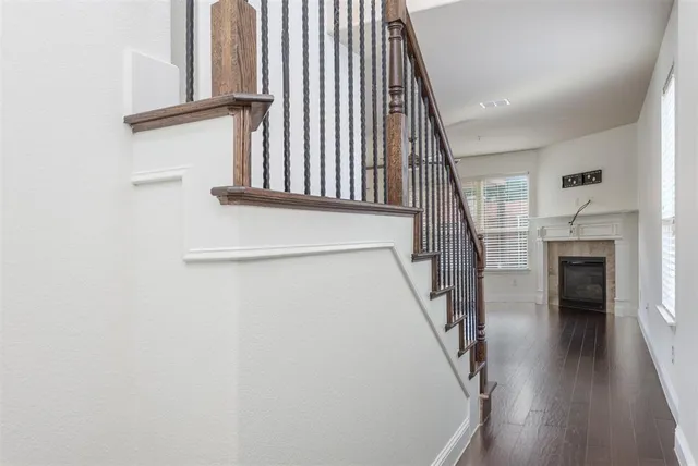 a view of staircase with white walls and a window
