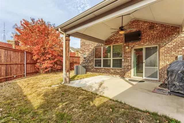 a view of a backyard with a wooden fence