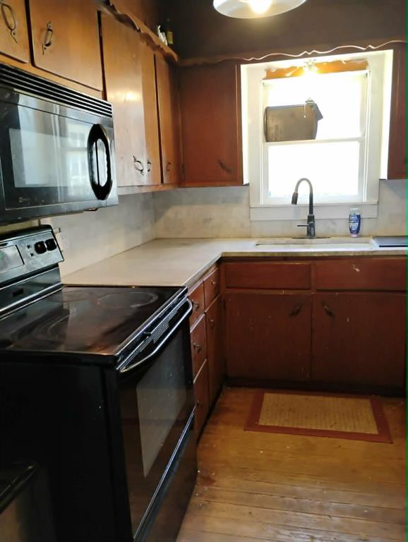763 Frontier Street Bowie, TX 76230 - Photo 21 of 28 a kitchen with a sink and a stove