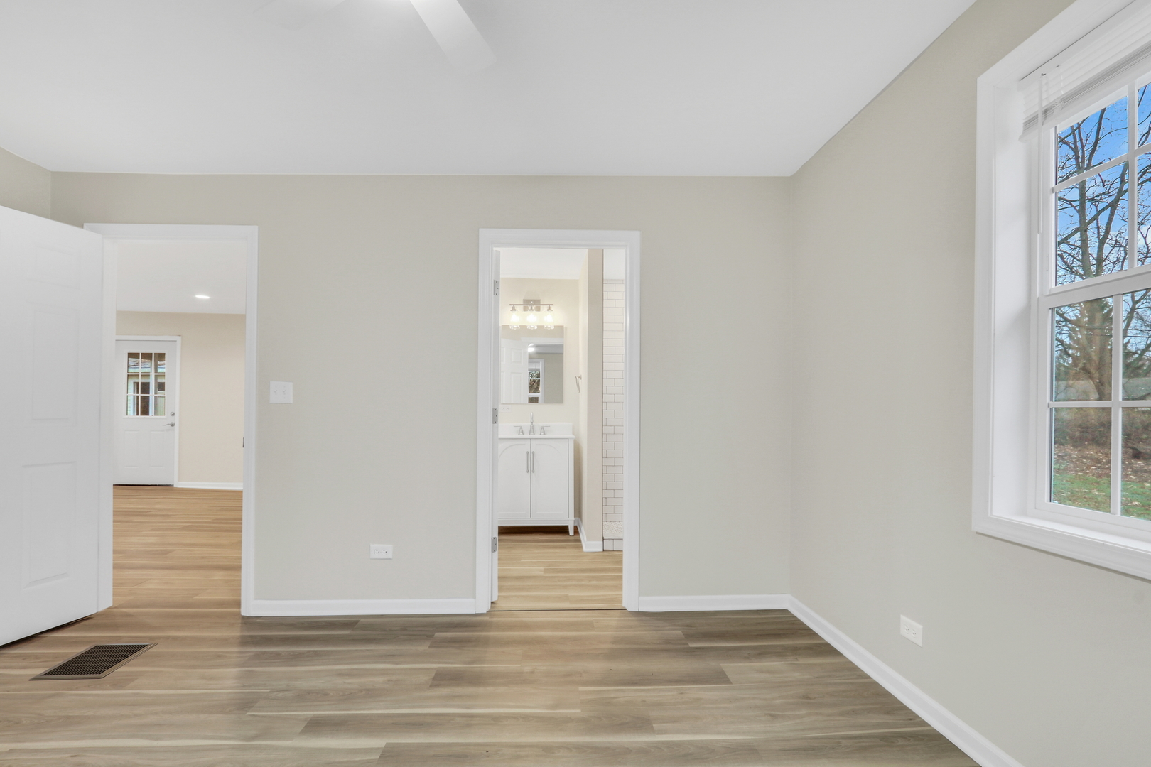 24791 West Rollins Road Round Lake, IL 60073 - Photo 13 of 26 a view of an empty room with wooden floor and window