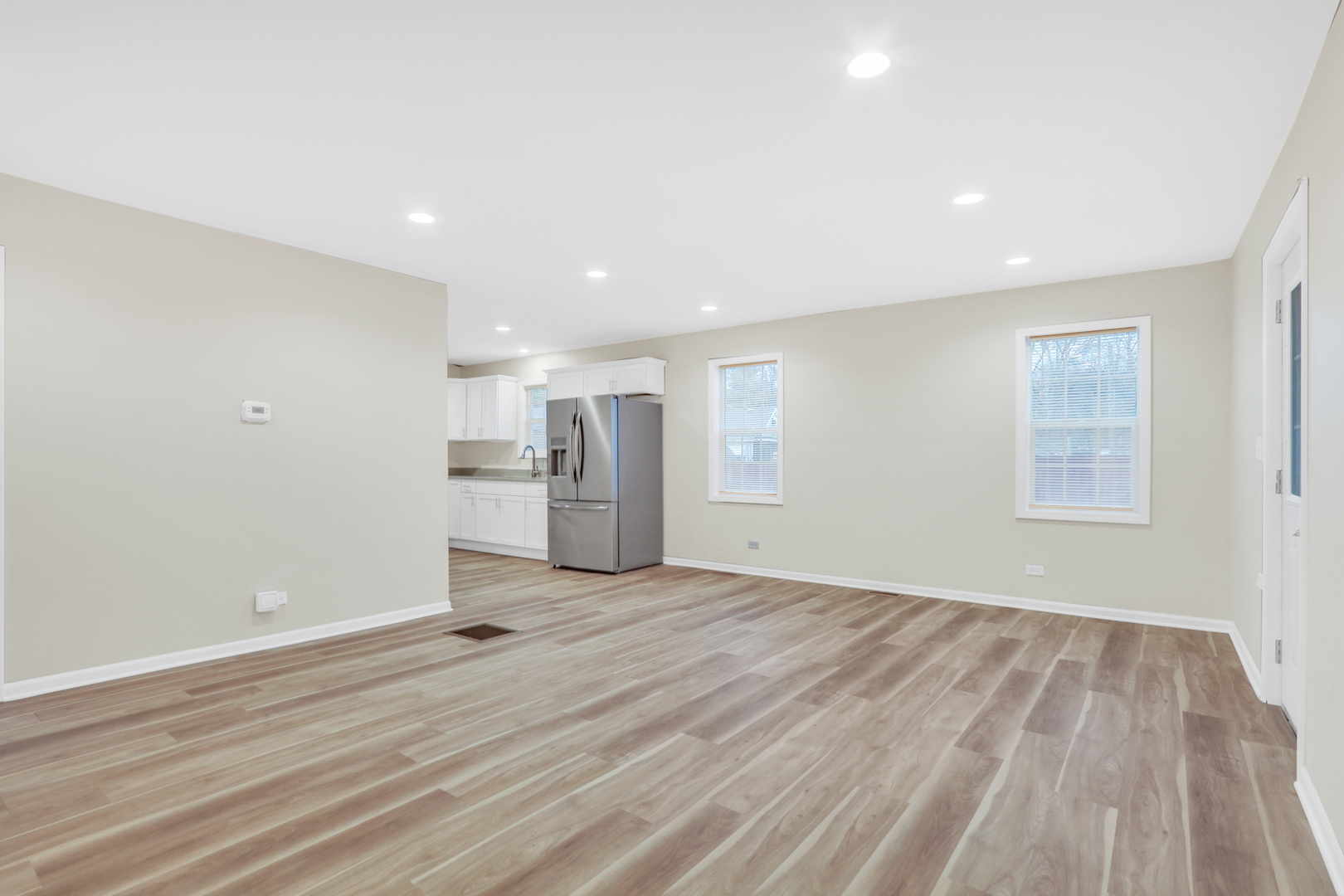 24791 West Rollins Road Round Lake, IL 60073 - Photo 4 of 26 a view of empty room with wooden floor and window