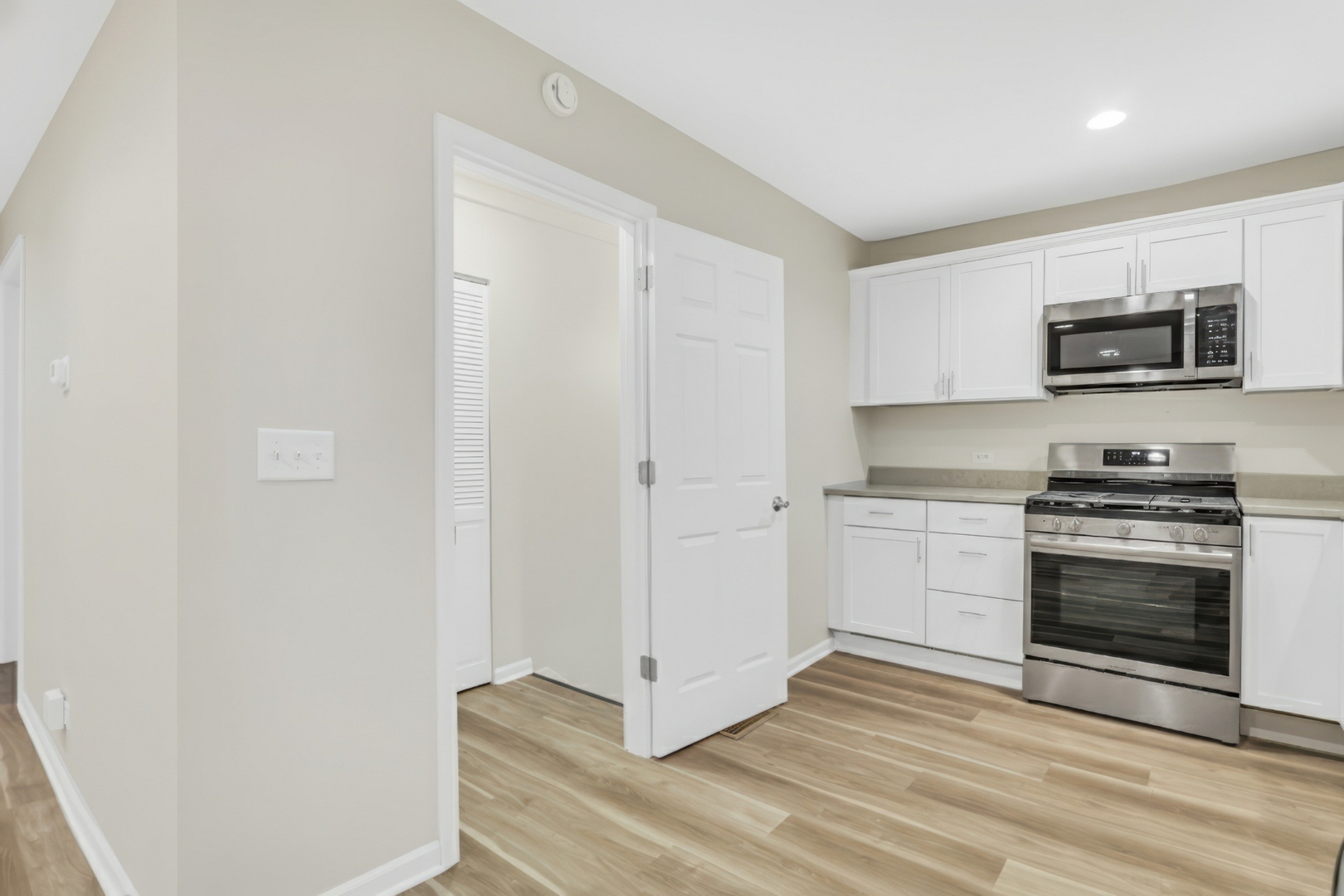 24791 West Rollins Road Round Lake, IL 60073 - Photo 9 of 26 a kitchen with stainless steel appliances a stove top oven a sink and a microwave