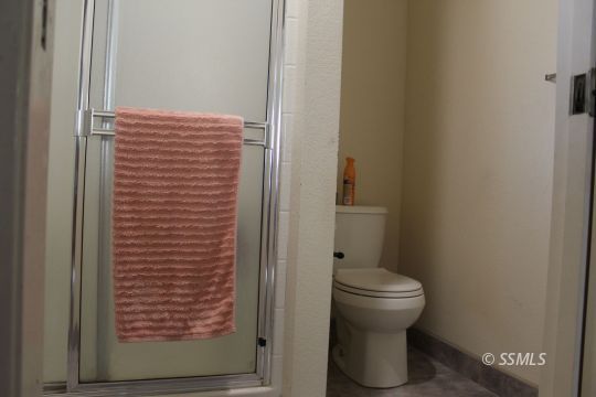 401 Ashton Street Ridgecrest, CA 93555 - Photo 28 of 36 a bathroom with a toilet and a shower