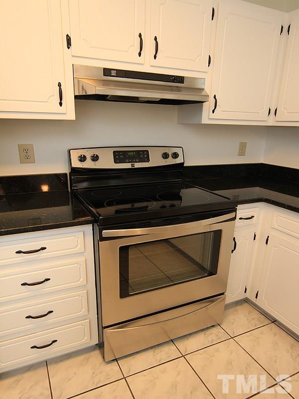 4605 Goldsmith Court Raleigh, NC 27613 - Photo 4 of 20 a kitchen with stainless steel appliances a stove and cabinets