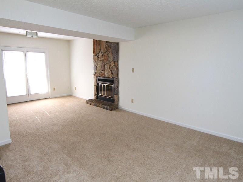 4605 Goldsmith Court Raleigh, NC 27613 - Photo 6 of 20 a view of empty room with a fireplace