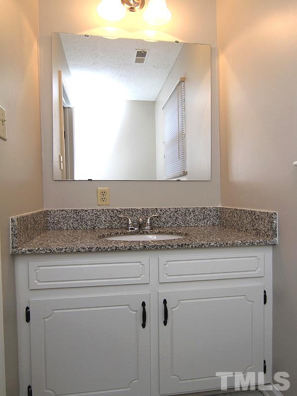 4605 Goldsmith Court Raleigh, NC 27613 - Photo 10 of 20 a bathroom with a granite countertop double vanity sink and mirror
