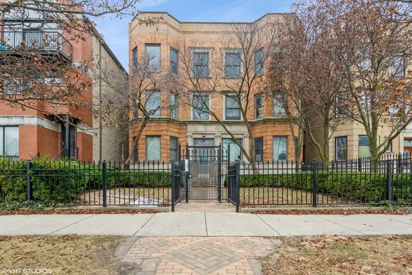 a view of a brick building next to a yard