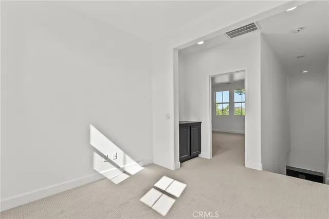 an empty room with windows and wooden floor