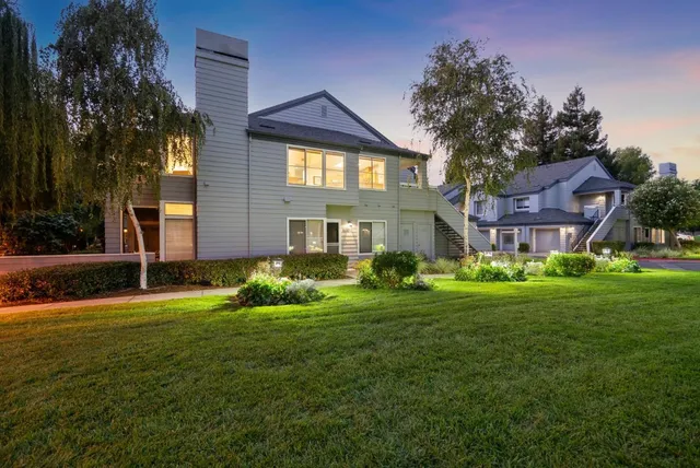 a view of a kitchen with a sink and a large window