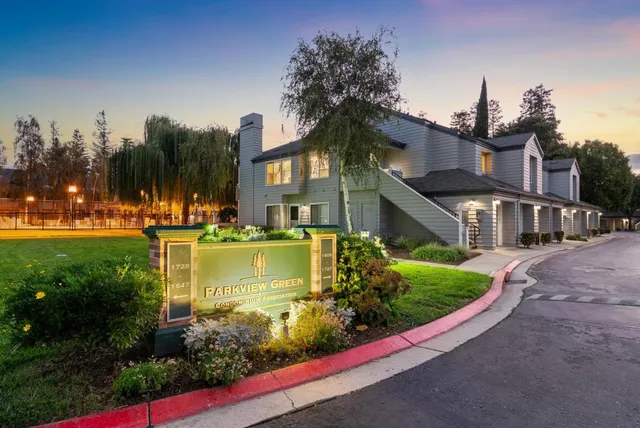 a dining room with furniture a large window and a chandelier