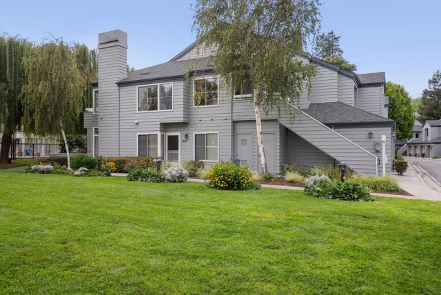 a living room with furniture a chandelier and a flat screen tv