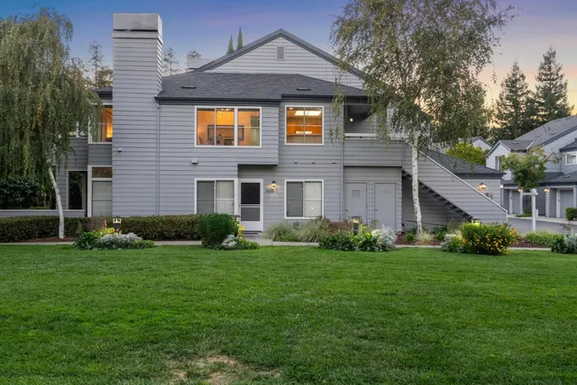 a front view of a house with a garden