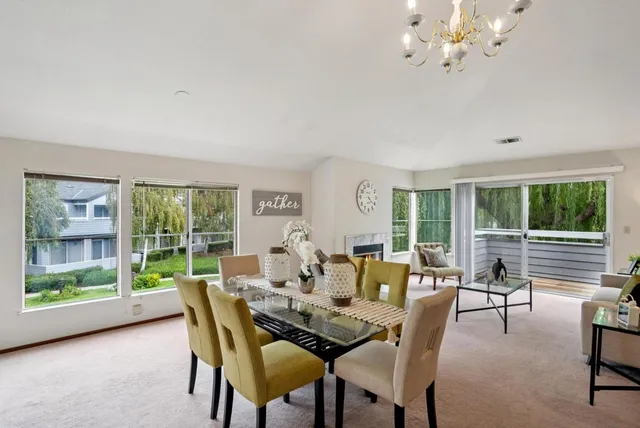 a view of a house with swimming pool and sitting area