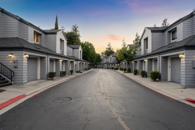 a bedroom with a bed and a lamp on table