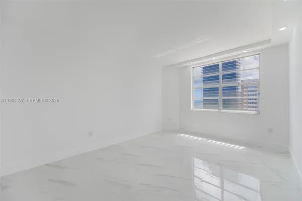 a view of an empty room with a window